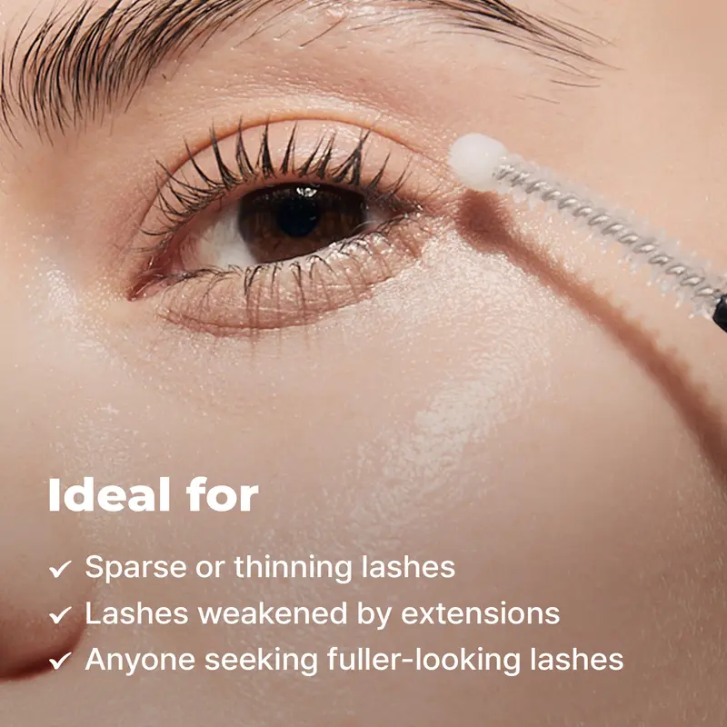 Applying lash serum along the upper lash line